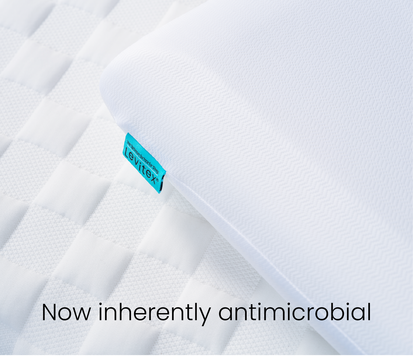 White mattress with antimicrobial feature label on a white background