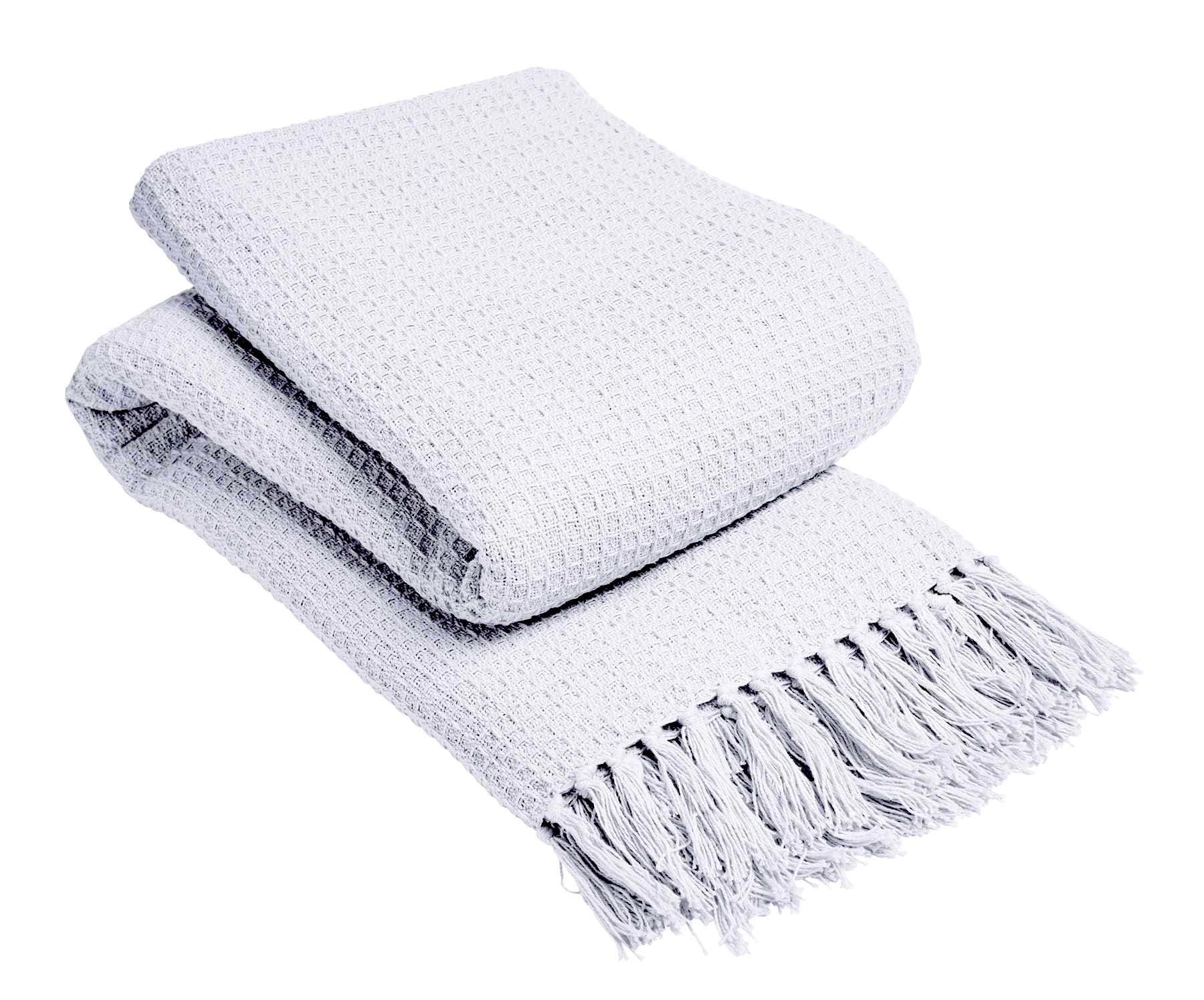 White textured throw blanket with fringe on a white background