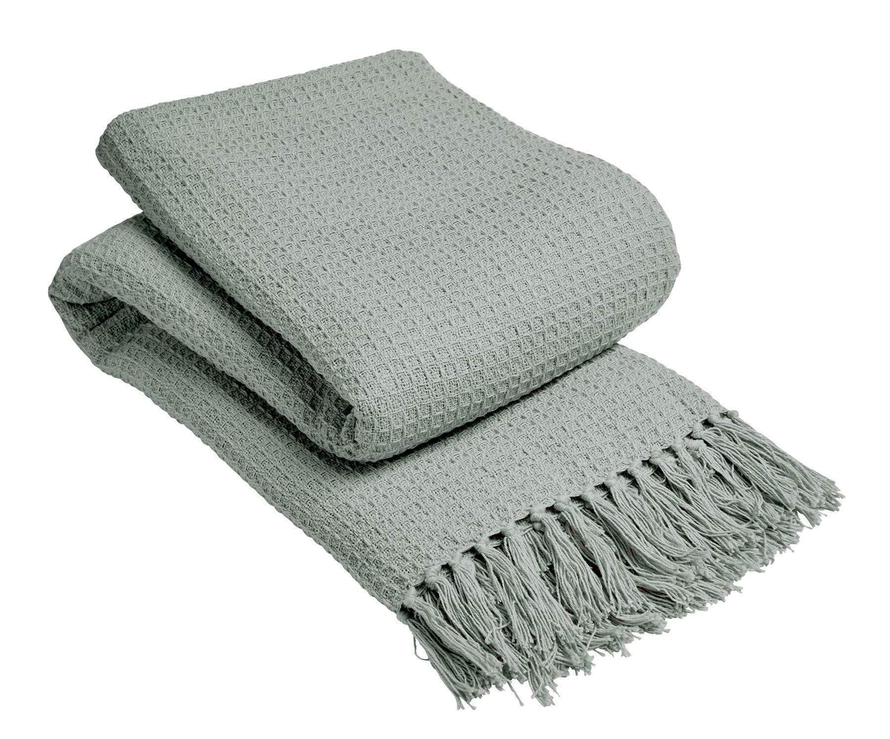 Folded gray throw blanket with fringes on a white background