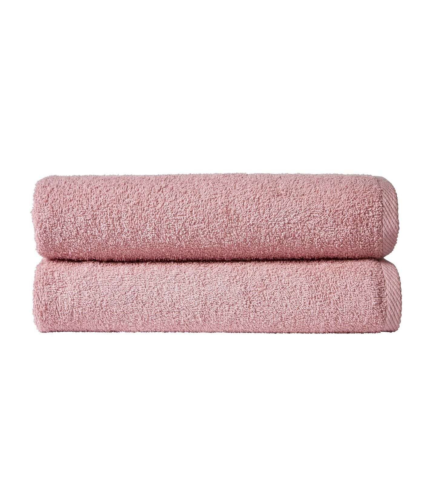 Two pink towels stacked on a white background